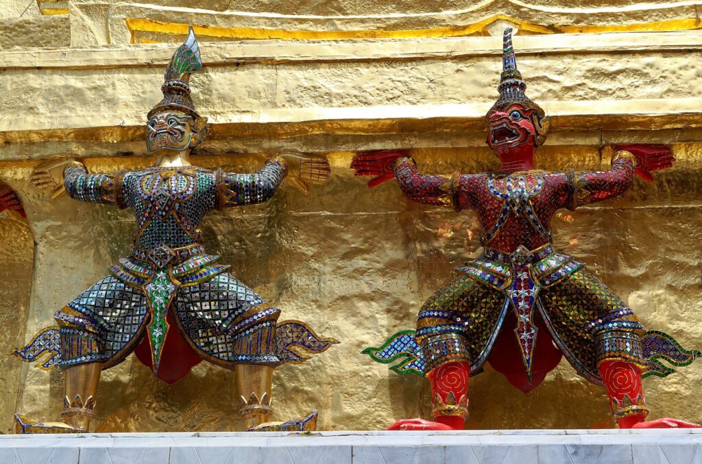 Grand Palace Bangkok: Yaksha guardians holding up a chedi